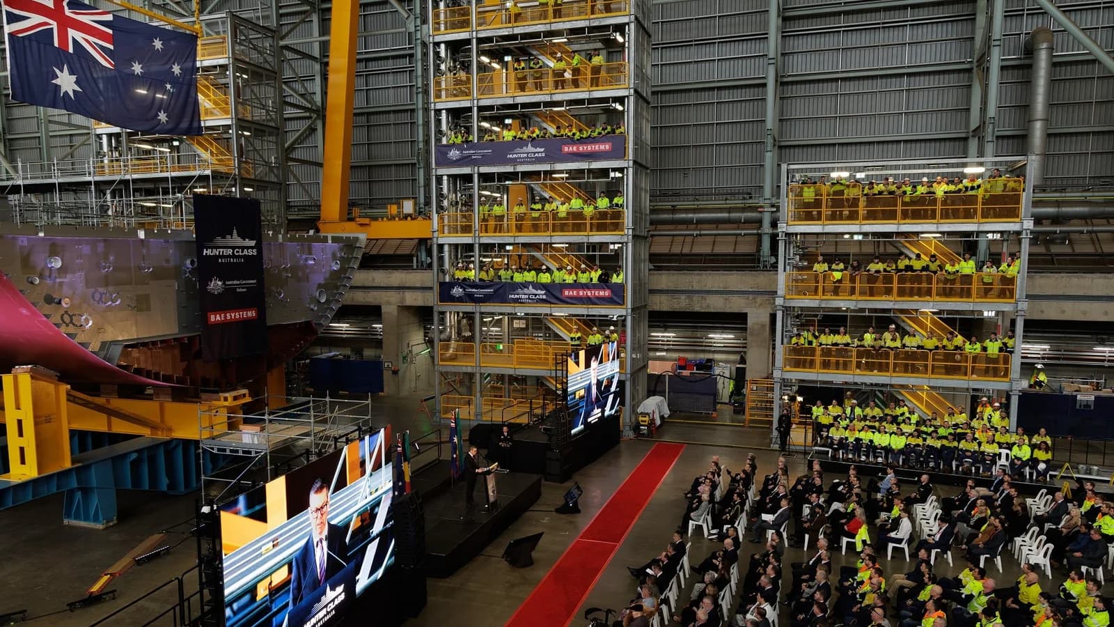 Australian Defence Minister Pat Conroy addresses shipyard workers and Defence representatives beside Hunter-class frigate sections at Osborne Naval Shipyard