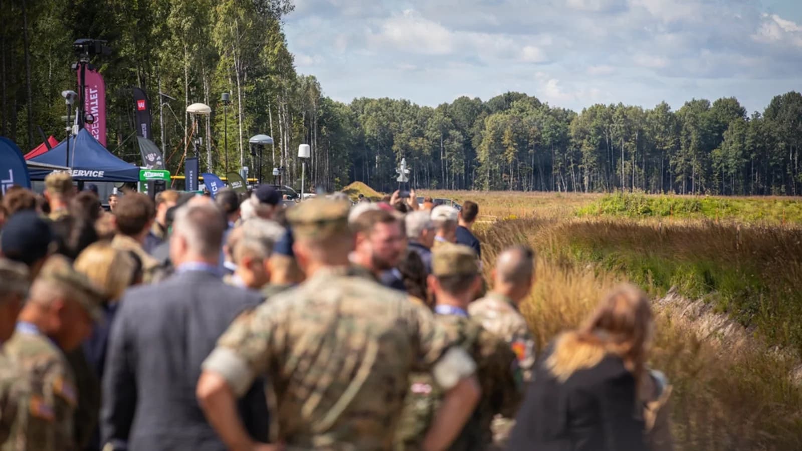 Military and civilian observers watch a counter-drone demonstration at Baltic Trust 2026 in Latvia
