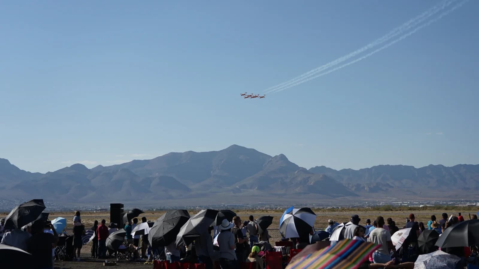 Snowbirds fly above an airshow audience at Fort Bliss, Texas, in October 2024; historical context.
