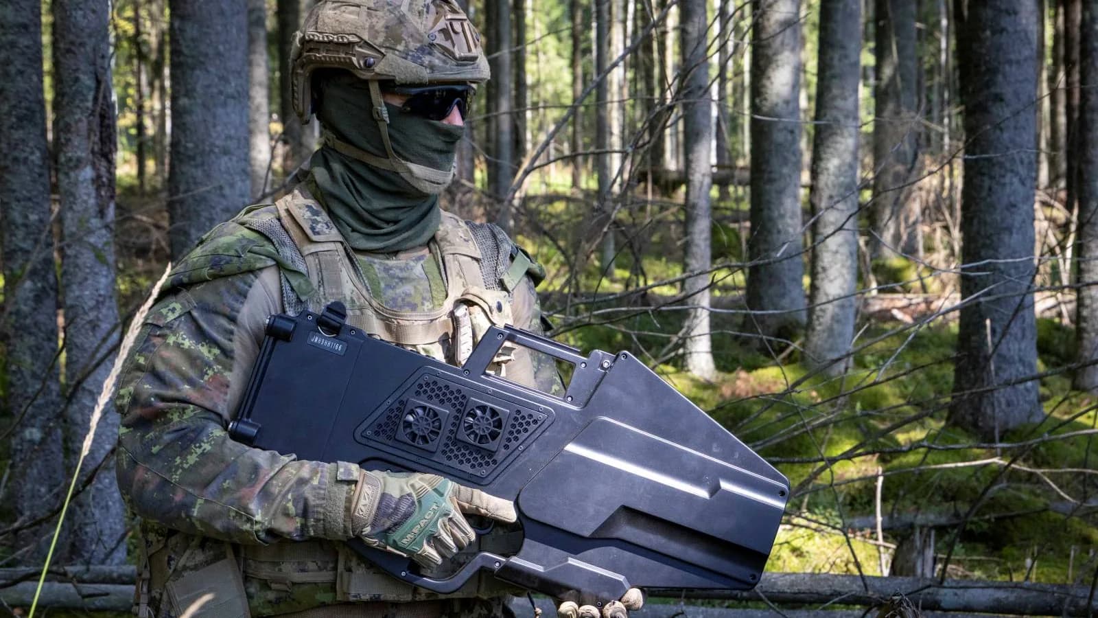 A soldier holds counter-drone equipment in a wooded exercise area in NATO’s October 16 account.