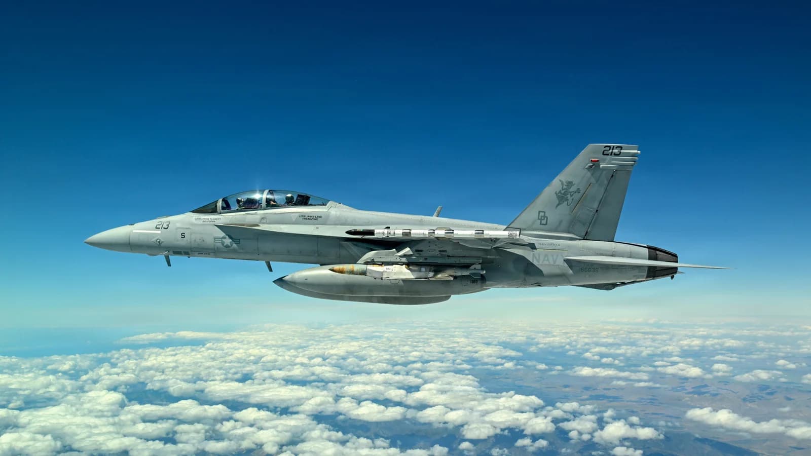 U.S. Navy F/A-18 Super Hornet carrying a JDAM LR test weapon in flight