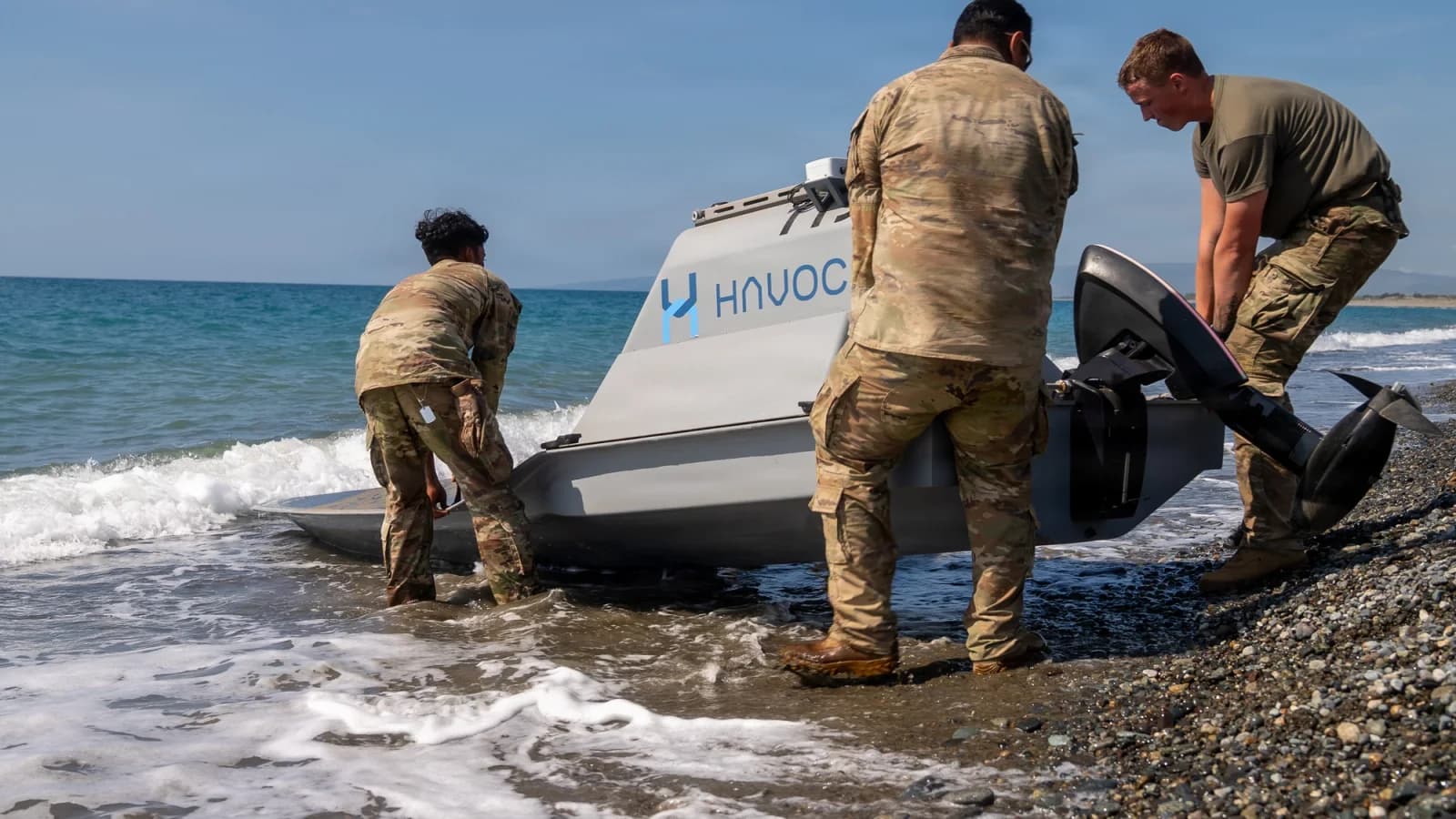 Soldiers prepare an uncrewed surface vessel at the shore during Balikatan 2026 in the Philippines