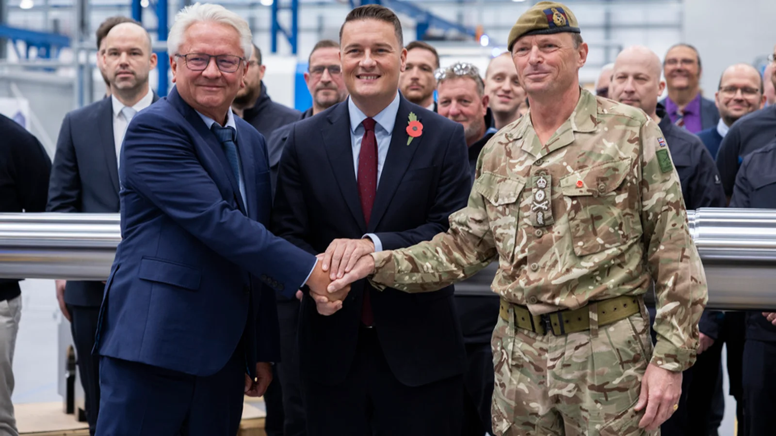 Officials mark the opening of the Telford gun hall beside a large-calibre barrel