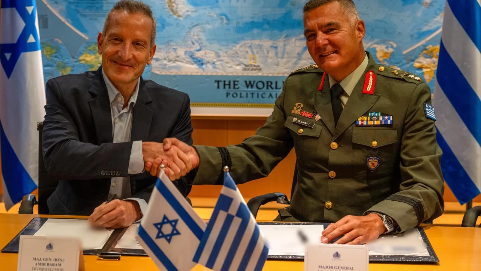 Israel Ministry of Defense director general Amir Baram and Greek defence investments chief Ioannis Bouras shake hands after signing the Achilles Shield agreement in Tel Aviv