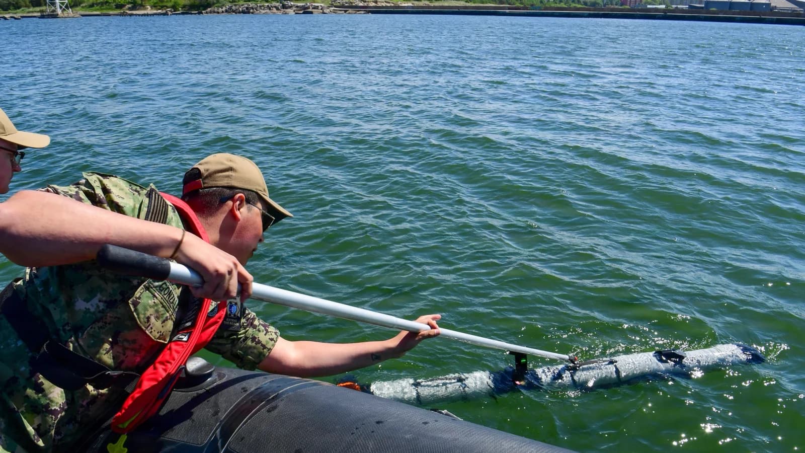 U.S. Navy personnel recover an Iver3 underwater vehicle during BALTOPS in June 2026; older trial background.